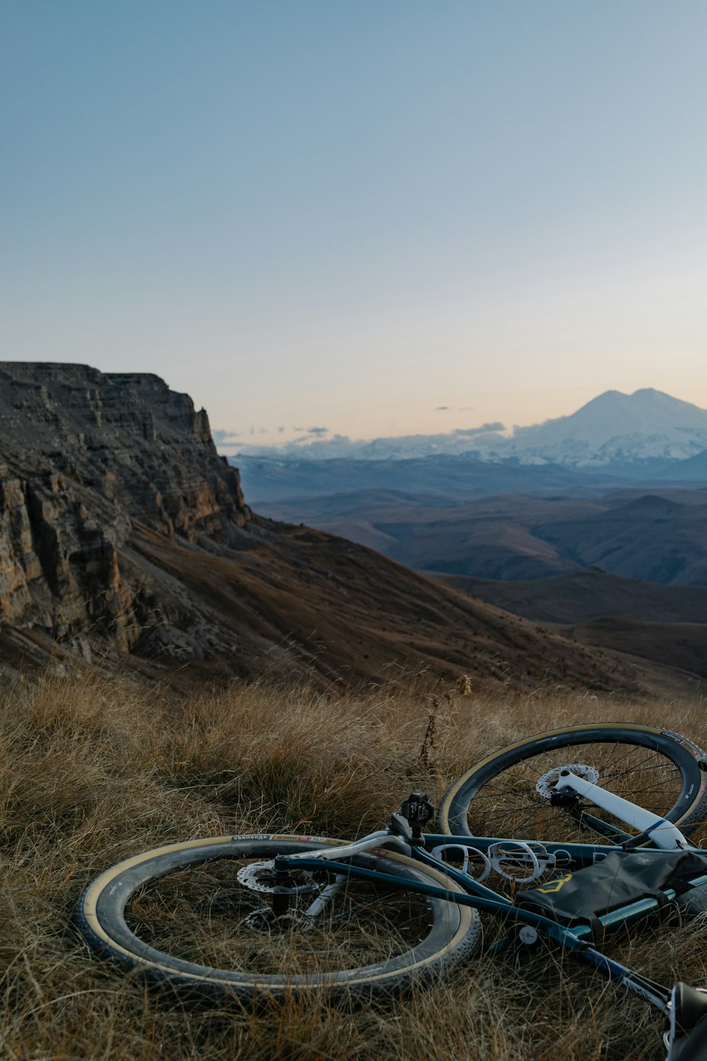 a bike laying on the ground in a field