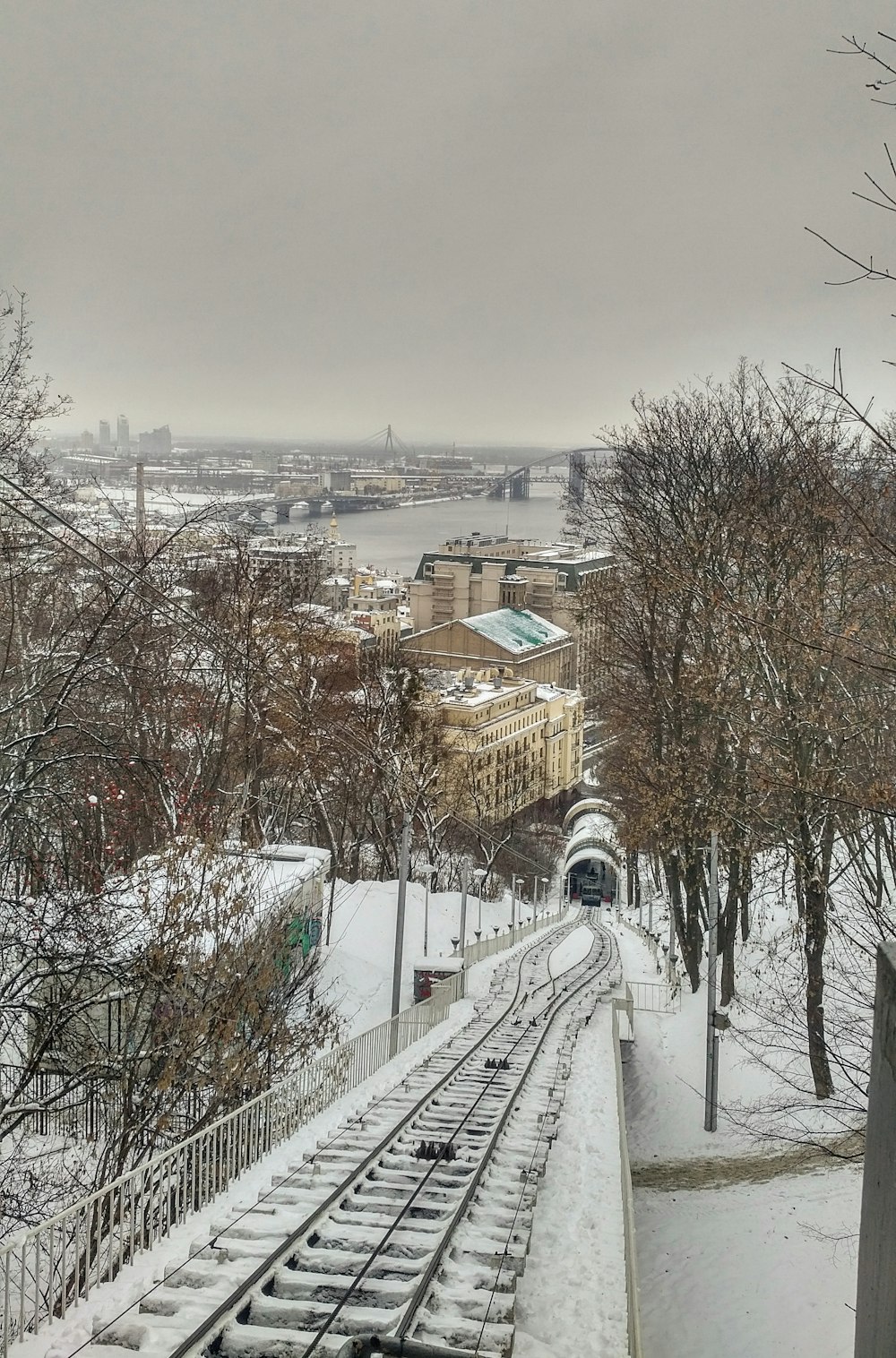 a view of a train track in the snow