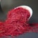 A close-up of bright red saffron threads on a white plate.