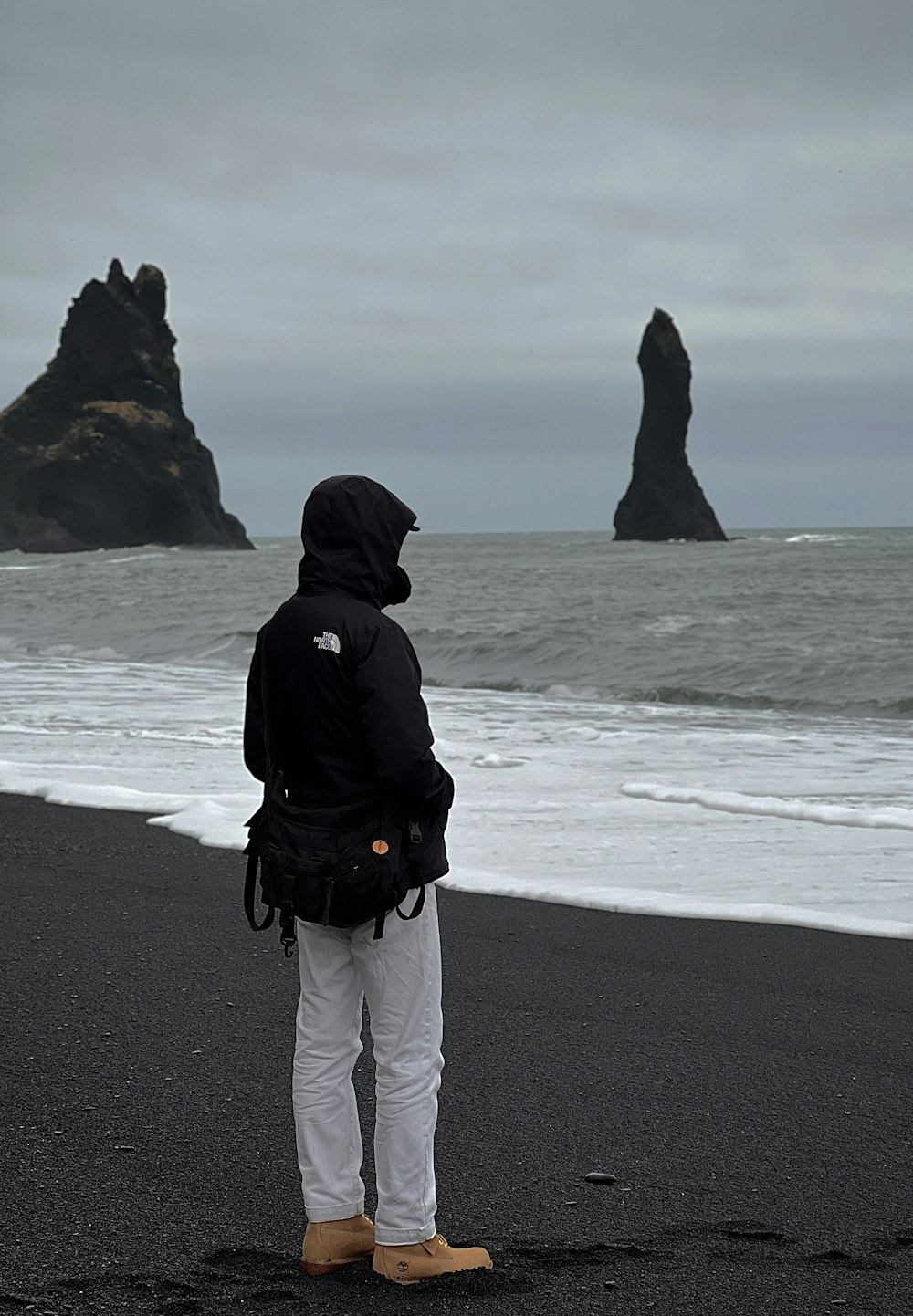 a person standing on a beach looking at the ocean