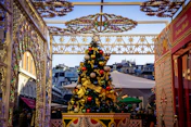 a decorated christmas tree in the middle of a street