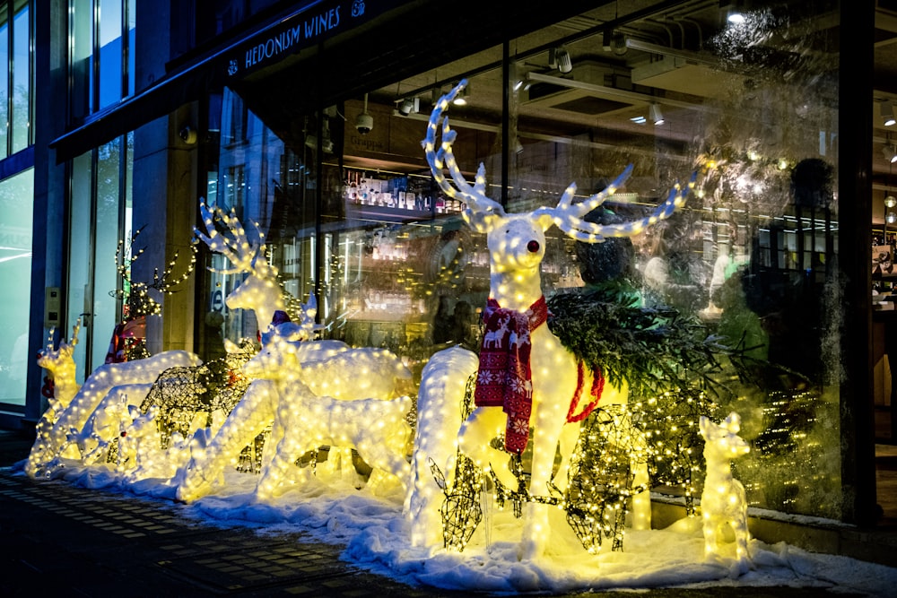 a christmas display of lighted reindeers in front of a building