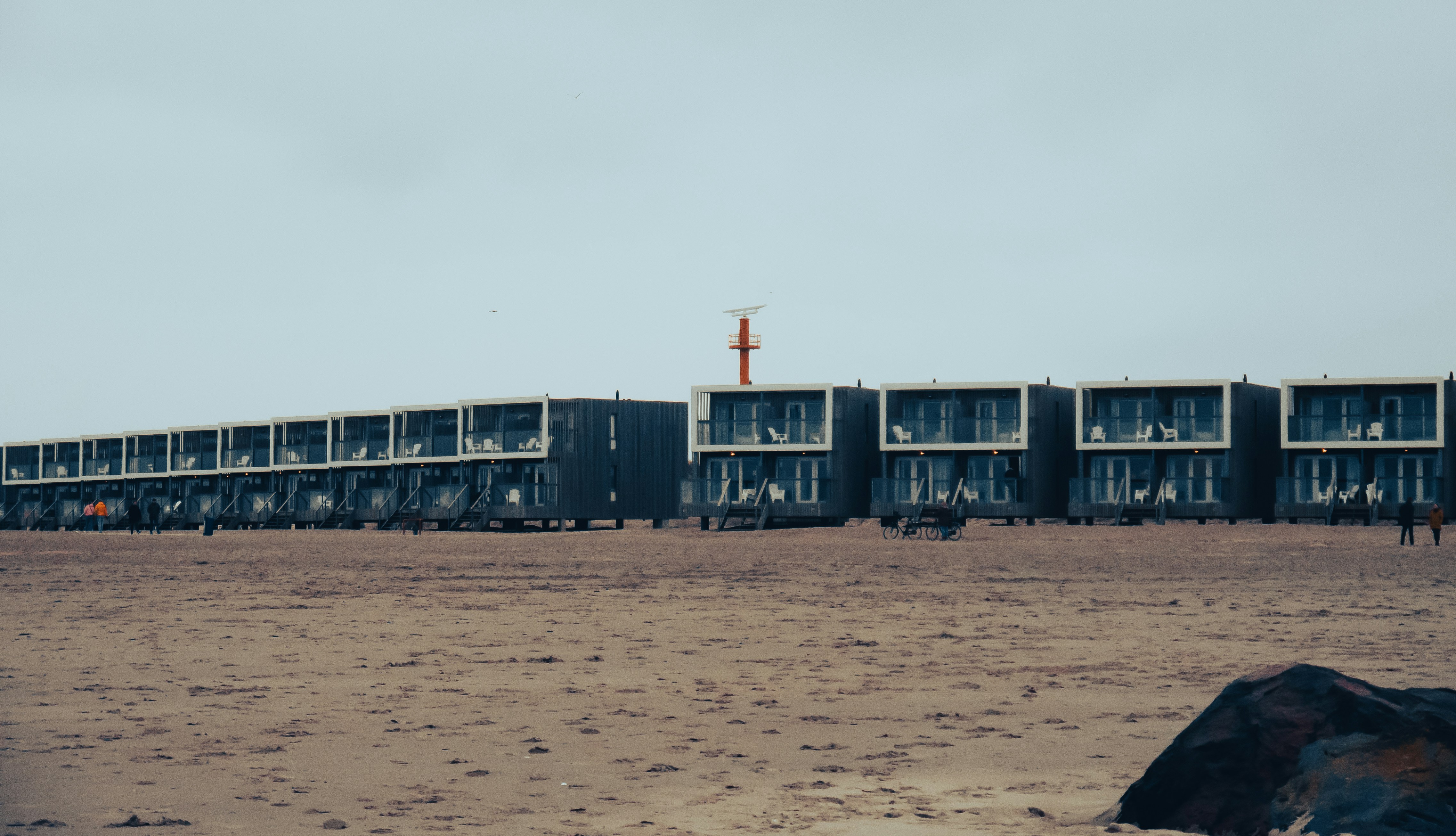 a large building sitting on top of a sandy beach