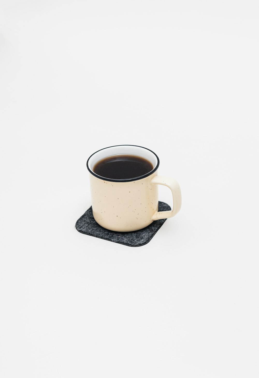 a cup of coffee sitting on top of a coaster