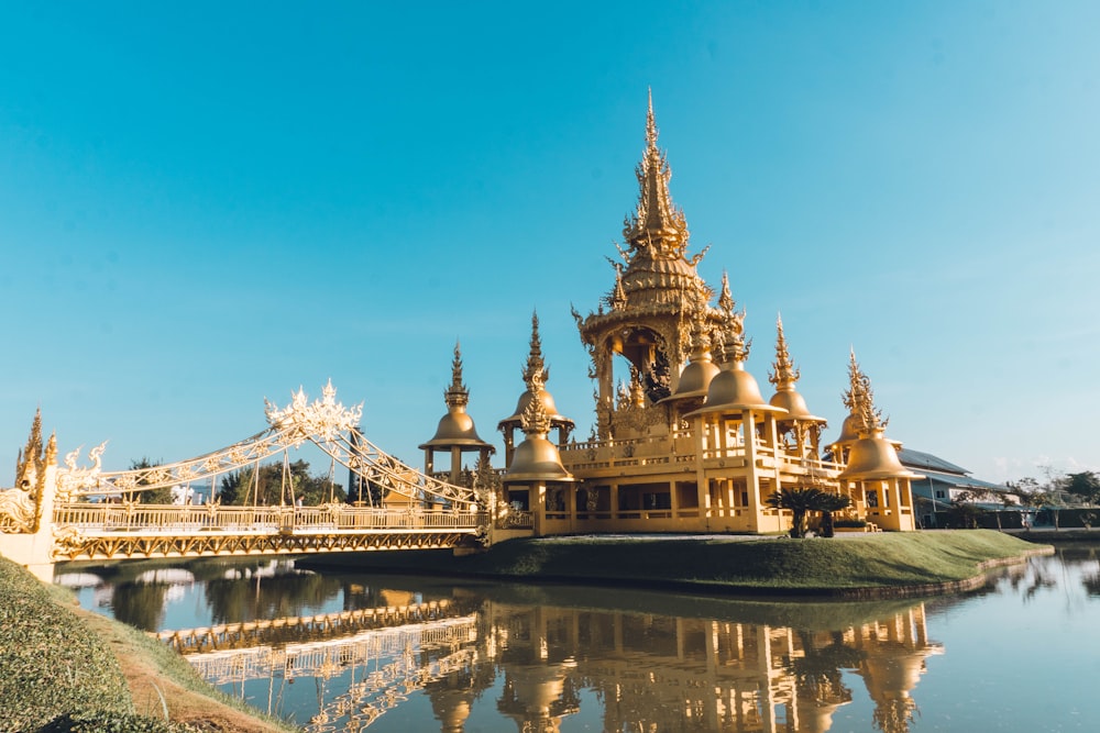 a large golden building sitting on top of a lake