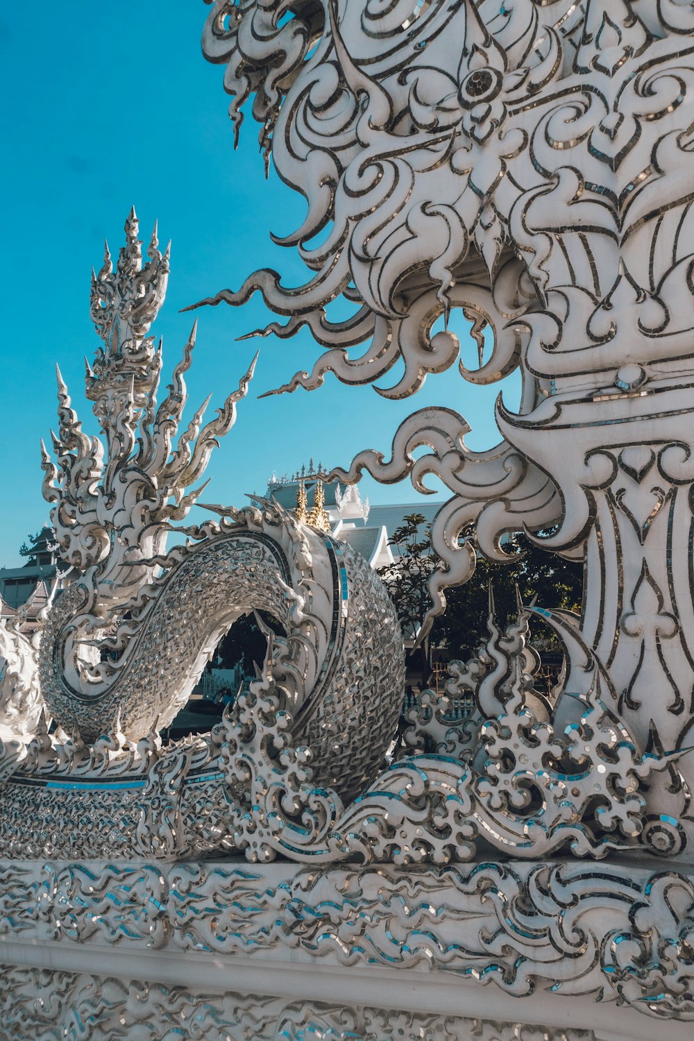 a white dragon statue sitting in front of a building