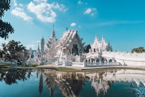 a large white building sitting next to a body of water