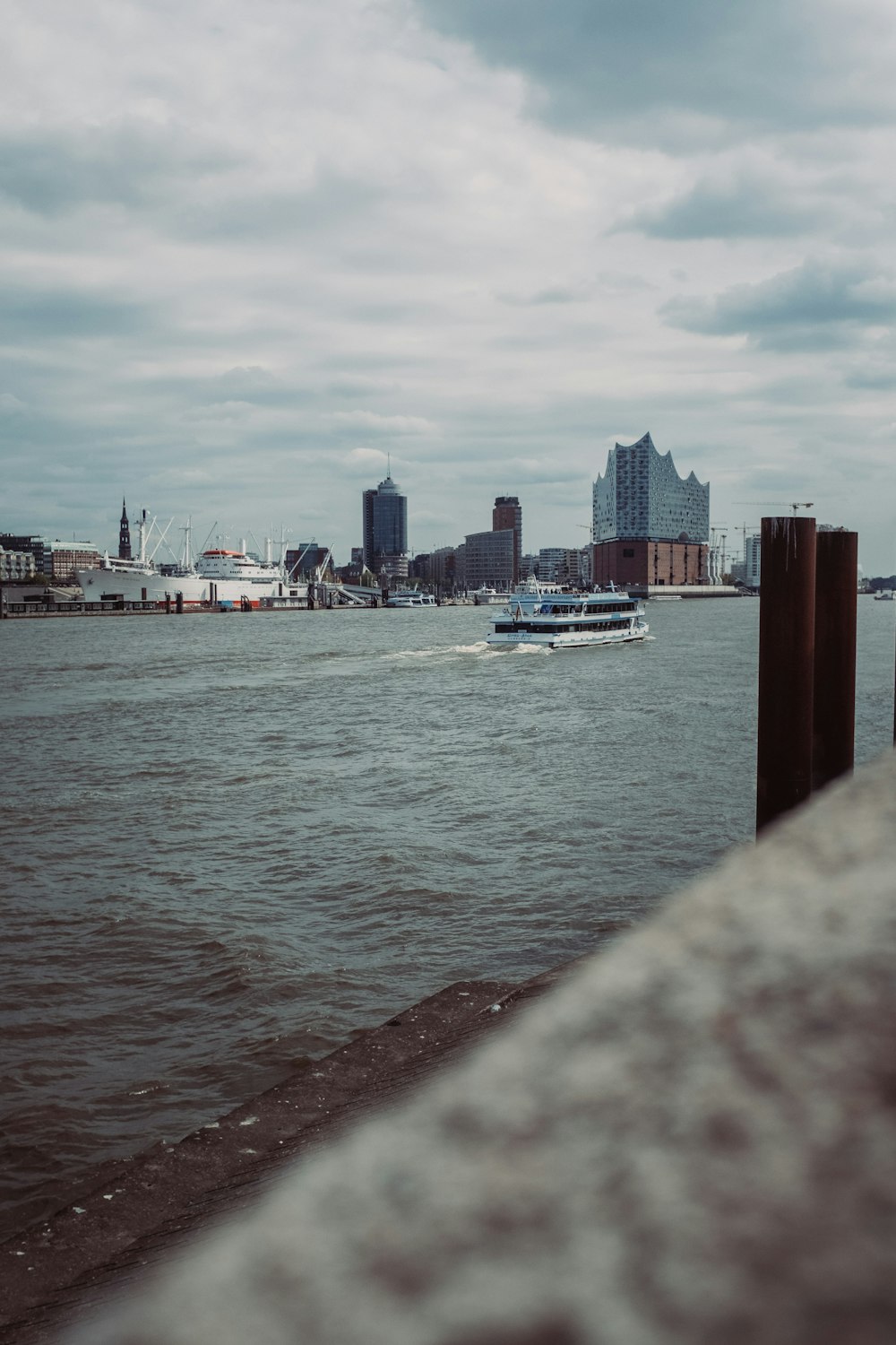 a boat traveling down a river next to tall buildings