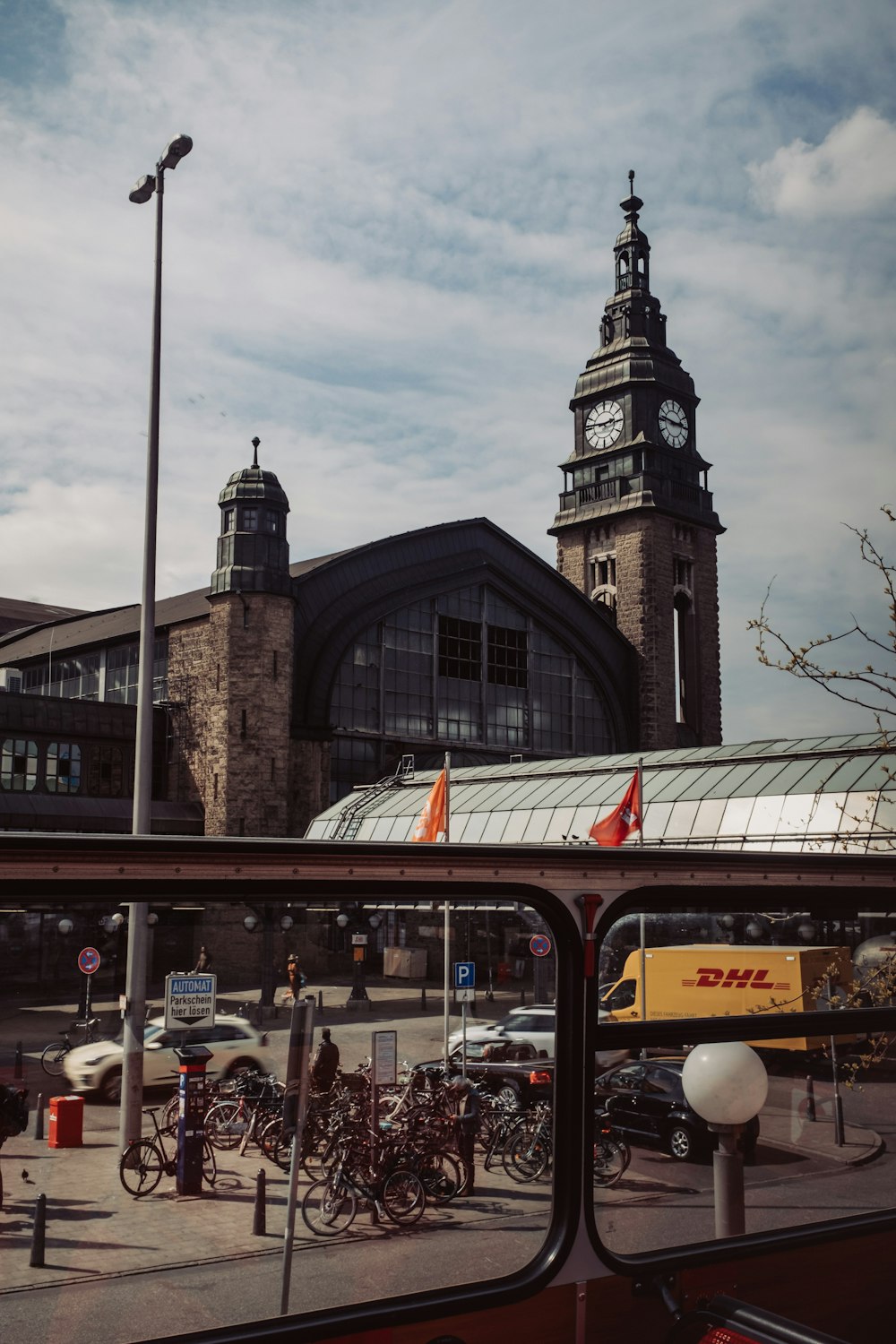 a view of a clock tower from a bus window