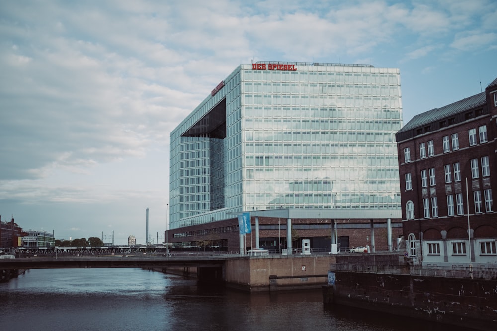 a very tall building sitting next to a body of water