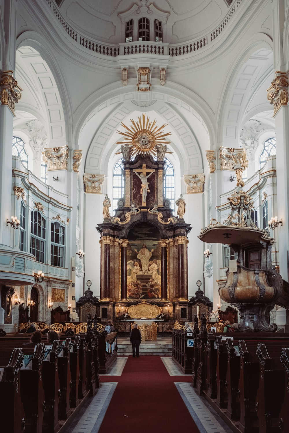 a church with a red carpet and a large alter