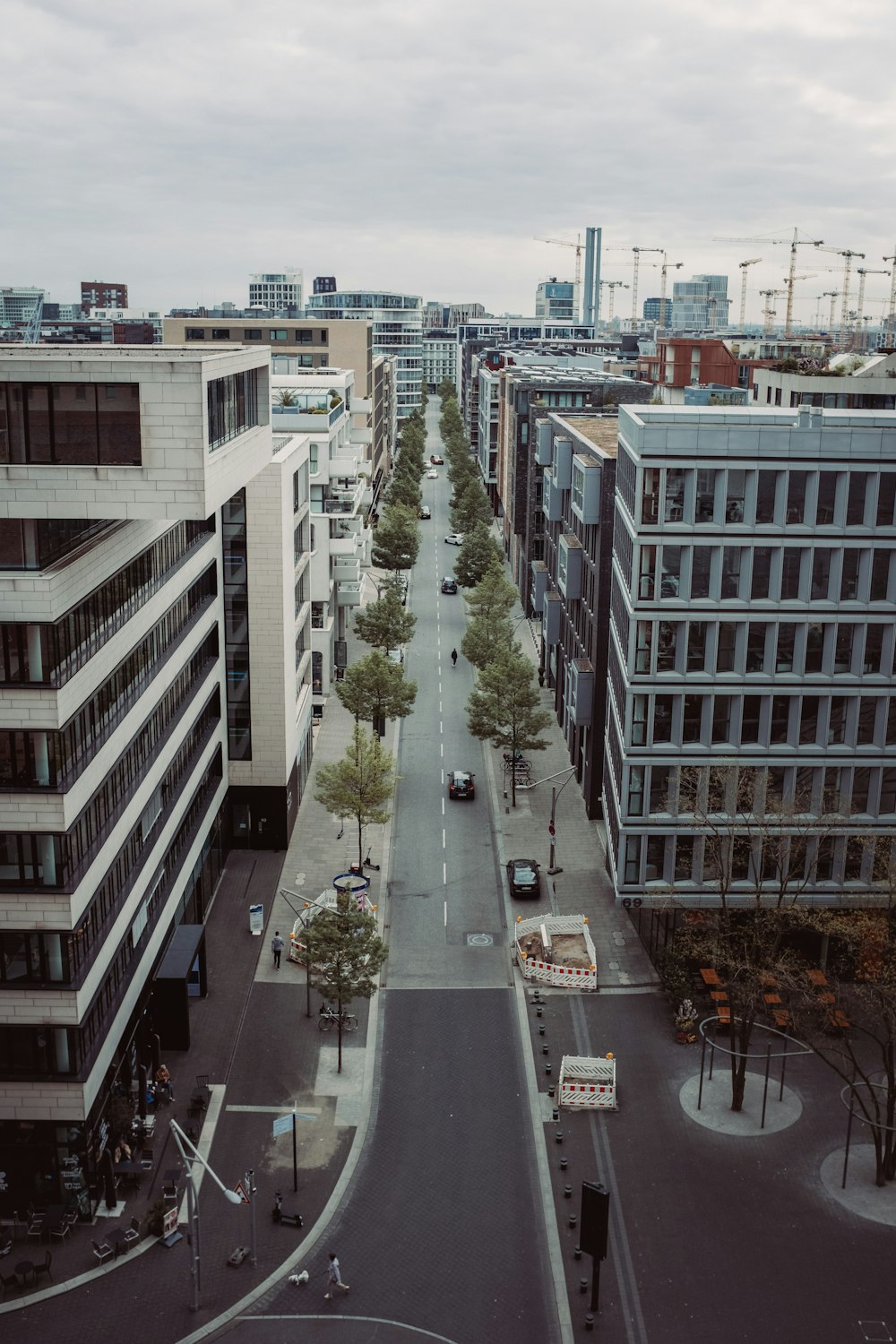 an aerial view of a city street with tall buildings