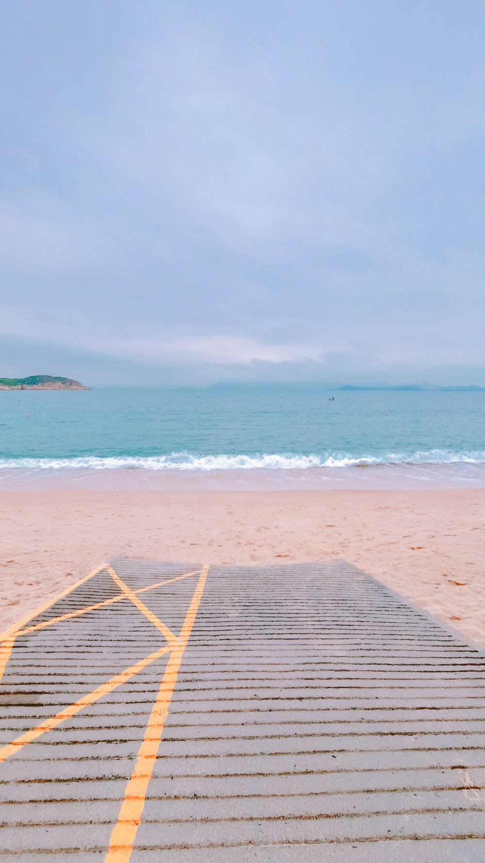 a bench sitting on top of a sandy beach