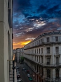 A vibrant sunset over the historic streets of Old San Juan with colorful buildings.