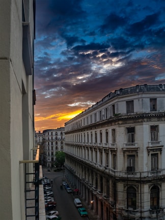 A vibrant sunset over the historic streets of Old San Juan with colorful buildings.