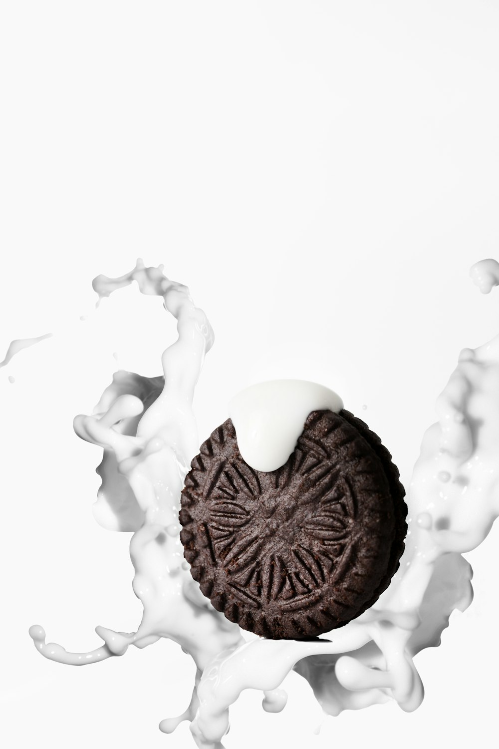 an oreo cookie with milk splashing out of it