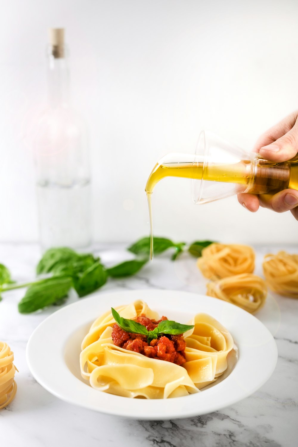 a white plate topped with pasta and sauce