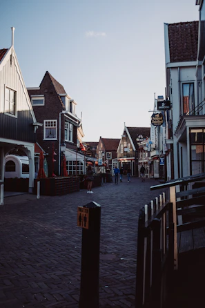 A calm European street scene featuring charming architecture and a cozy café.