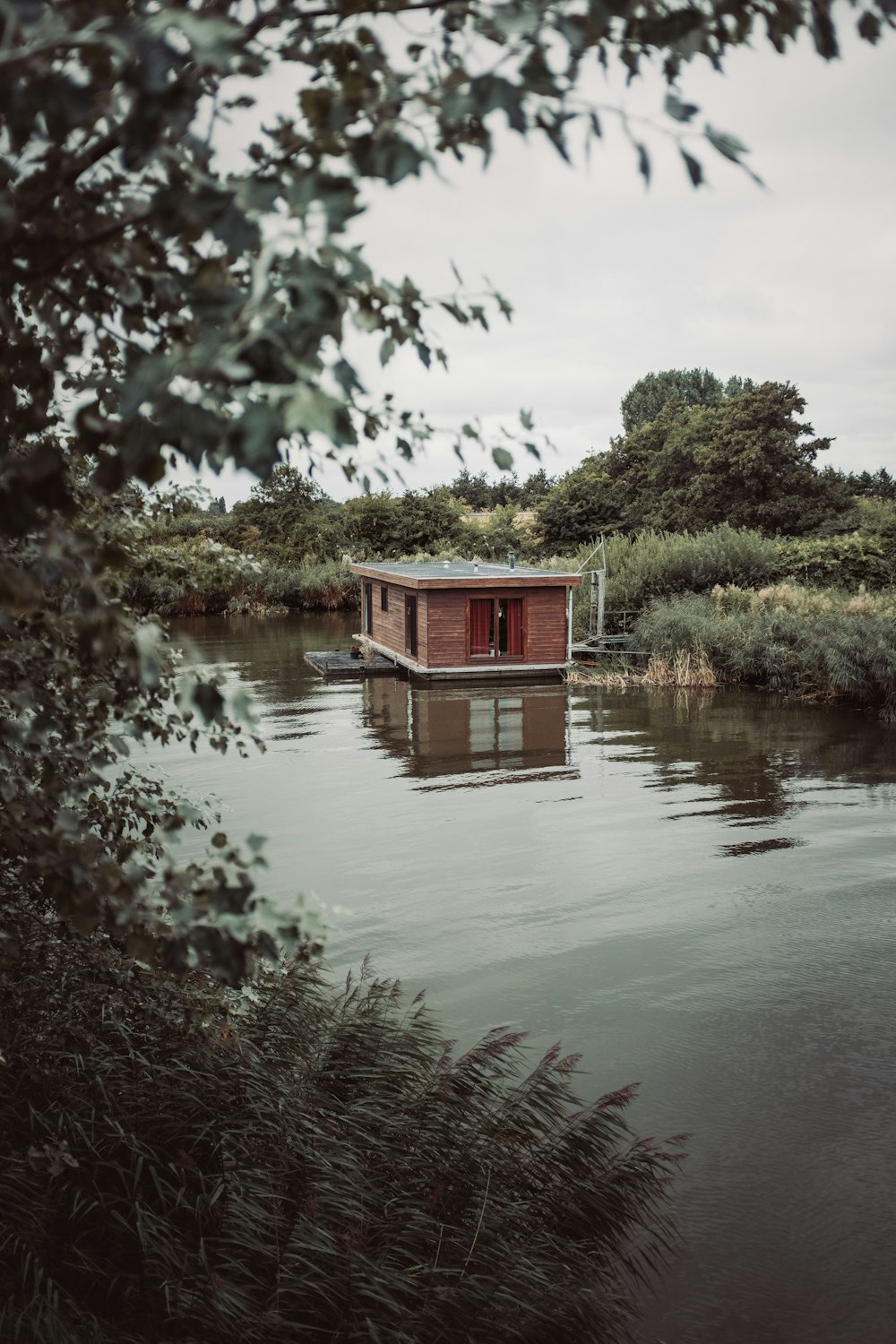 a houseboat floating on top of a body of water