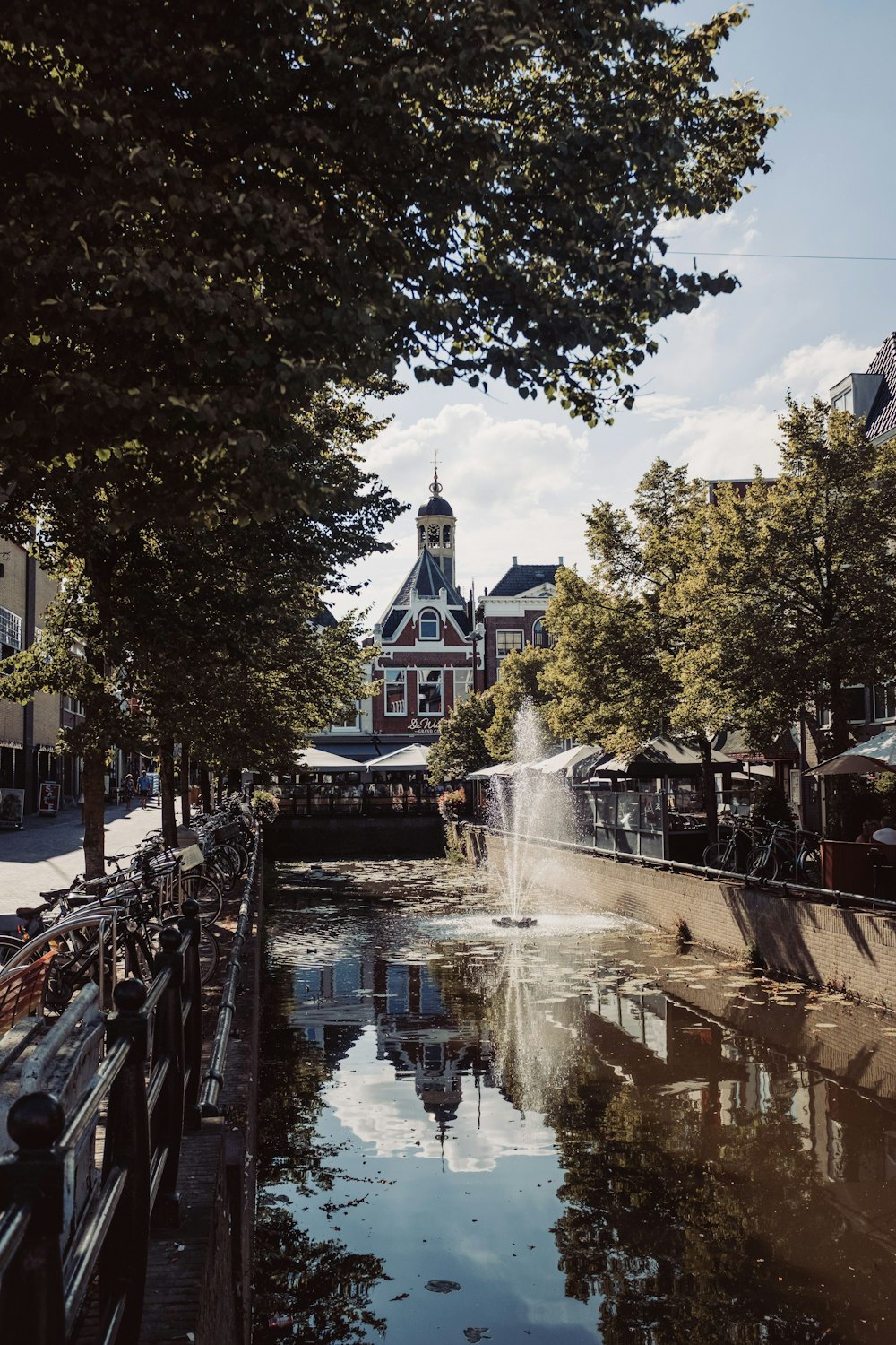 a canal with a clock tower in the background