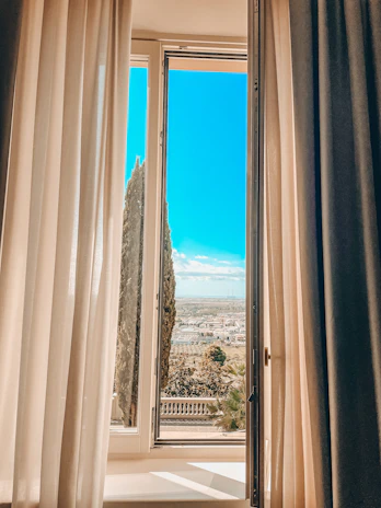 An open window revealing a peaceful morning sky, suggesting hope and new beginnings.