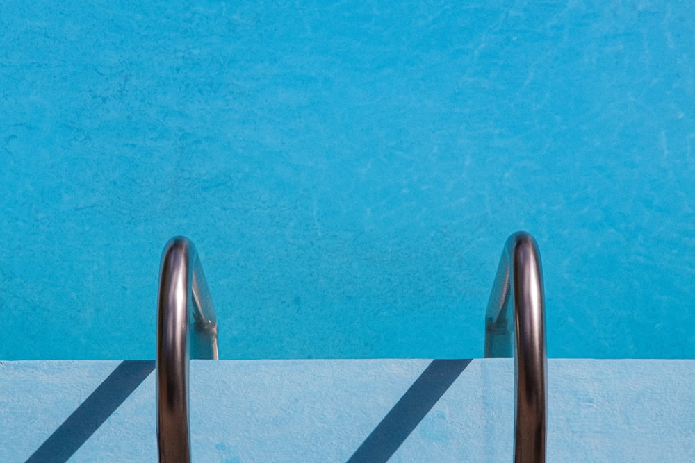 a swimming pool with a metal hand rail