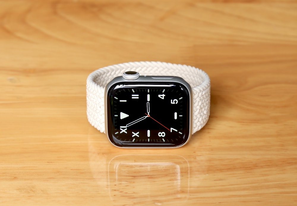 an apple watch sitting on top of a wooden table