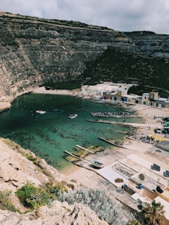 a body of water surrounded by a rocky cliff
