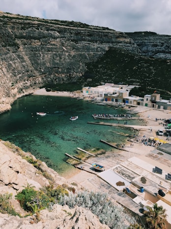 a body of water surrounded by a rocky cliff