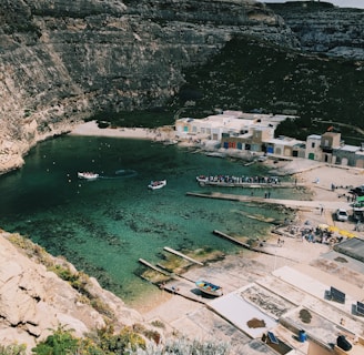 a body of water surrounded by a rocky cliff