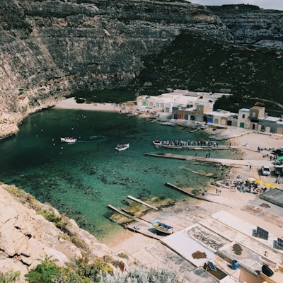 a body of water surrounded by a rocky cliff