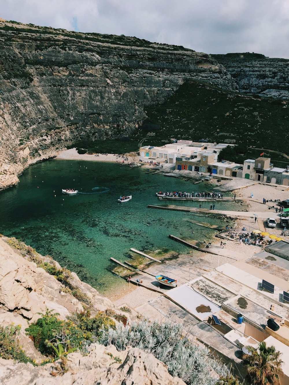 a body of water surrounded by a rocky cliff