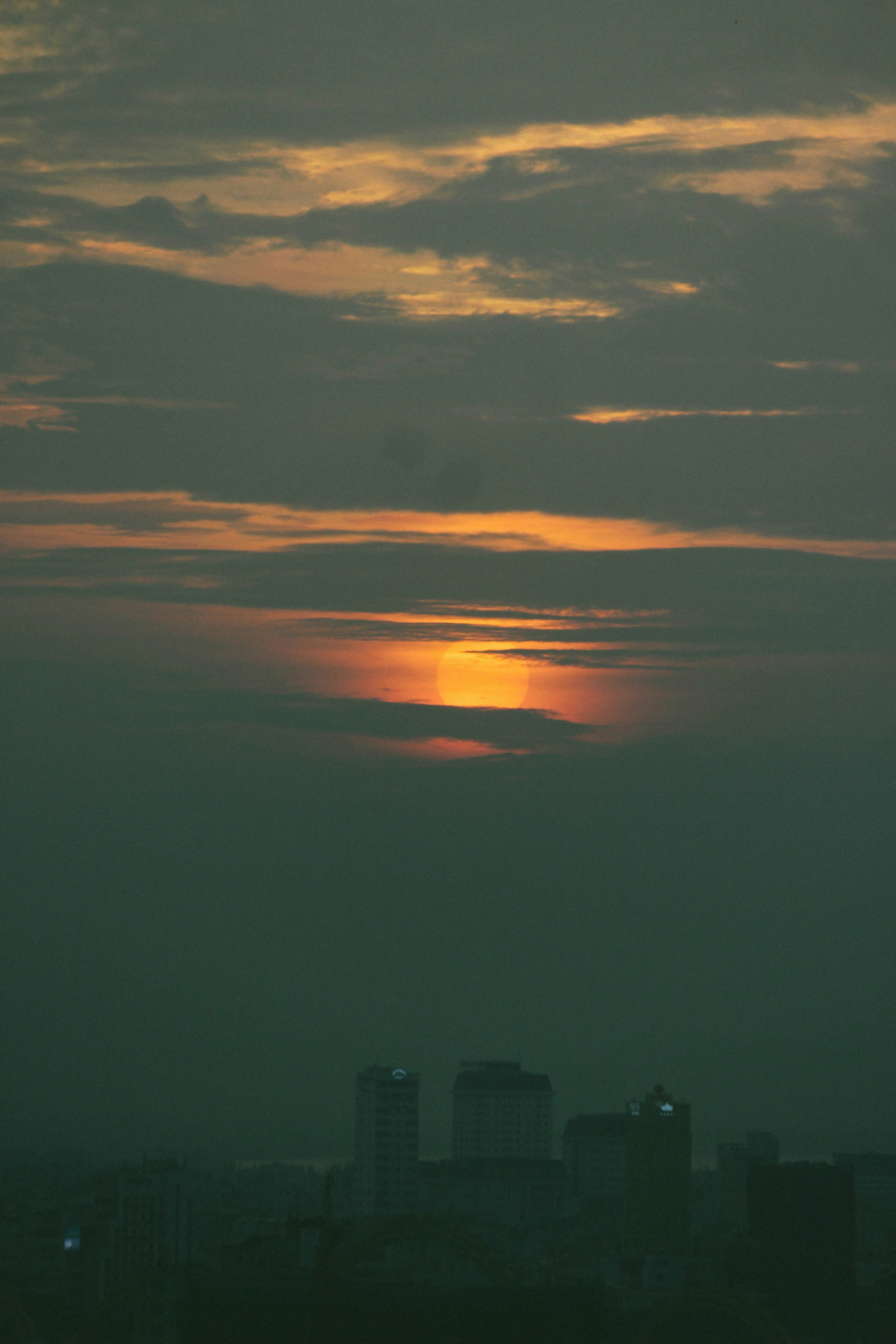 the sun is setting over a city skyline
