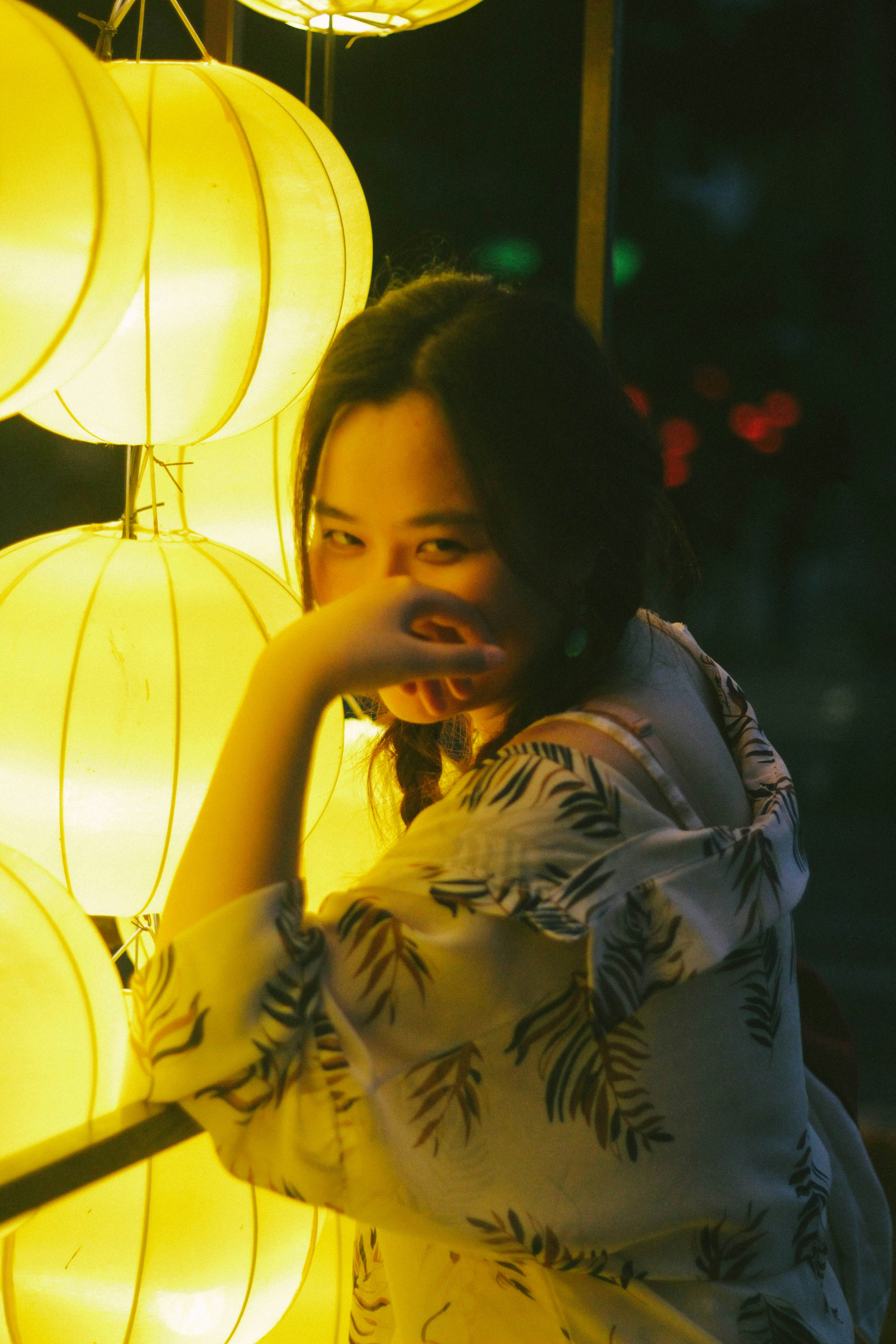 a woman standing next to a bunch of lights
