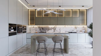 a modern kitchen with marble counter tops and stools