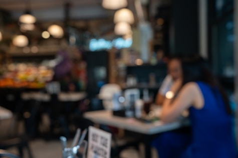 a blurry photo of a woman sitting at a table