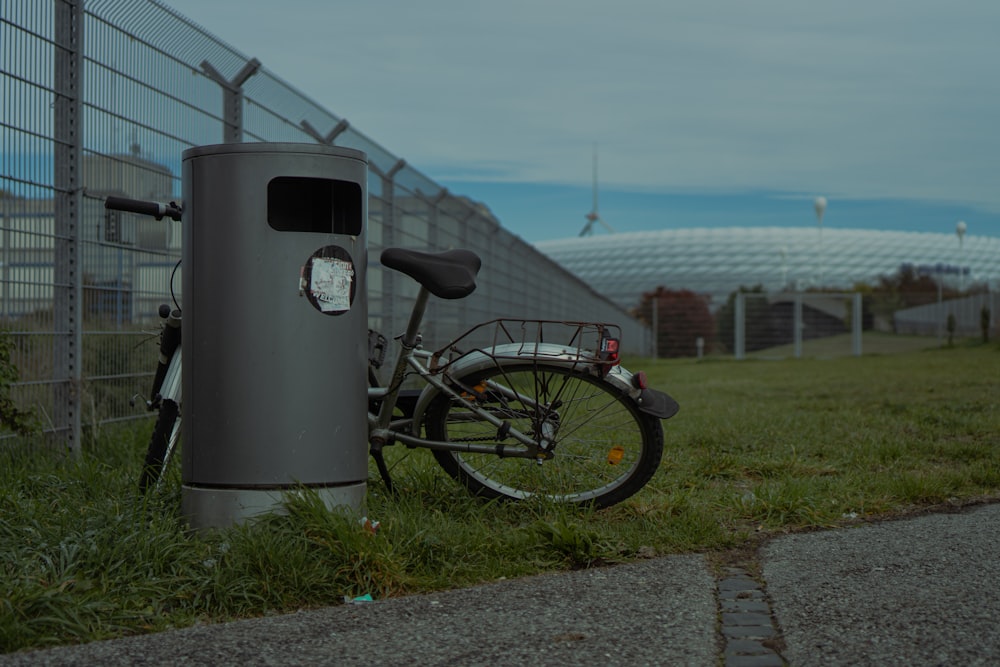 a bicycle parked next to a metal pole