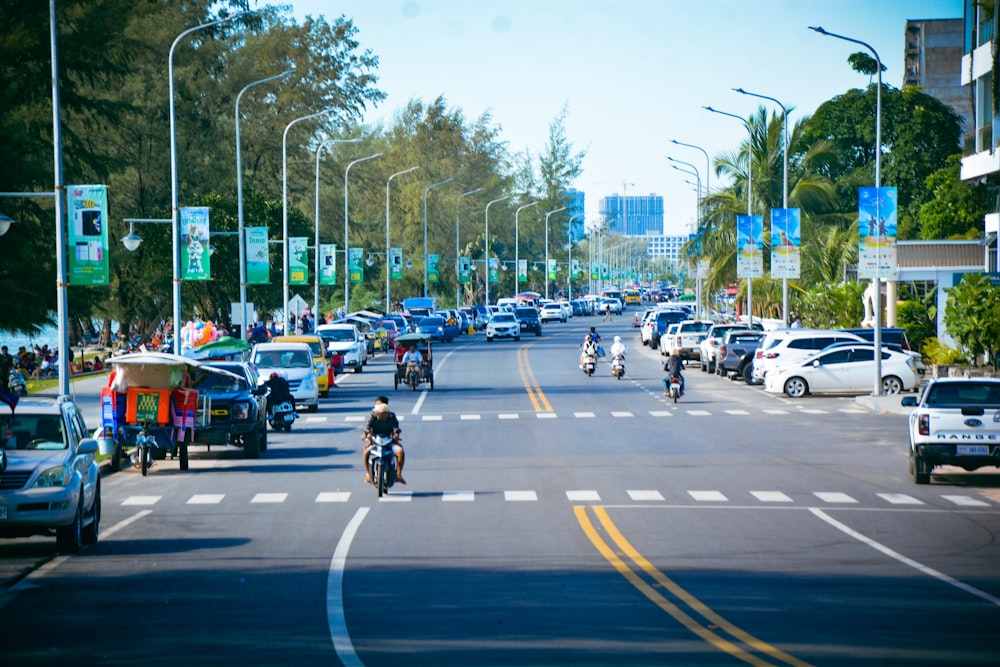 a group of people riding motorcycles down a street