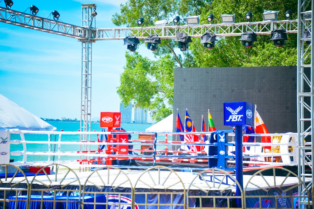 a stage set up on a beach with flags