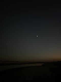 Evening scene of a luminous Helios V station softly illuminated under darkening blue sky.