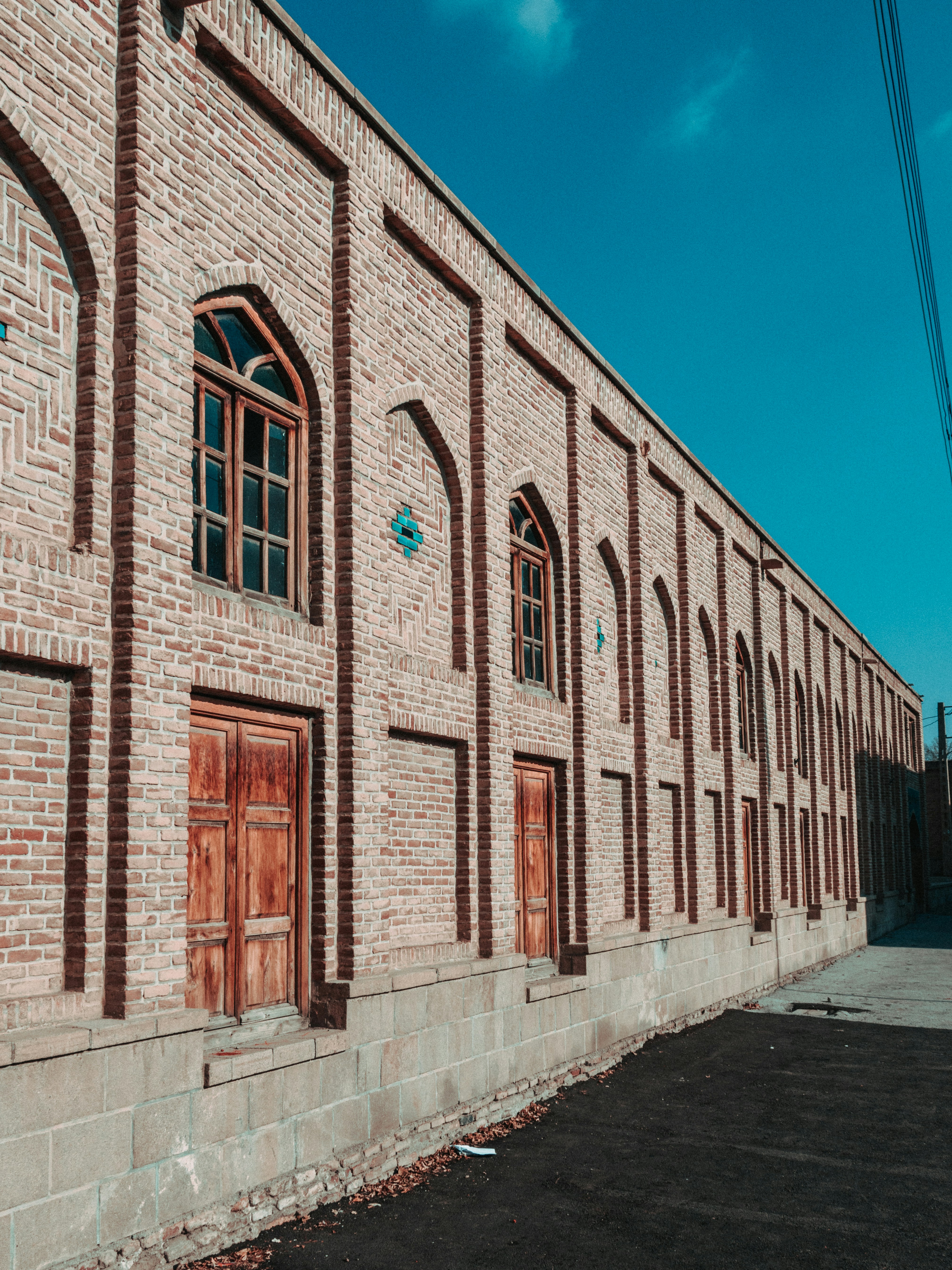 a brick building with wooden doors and windows