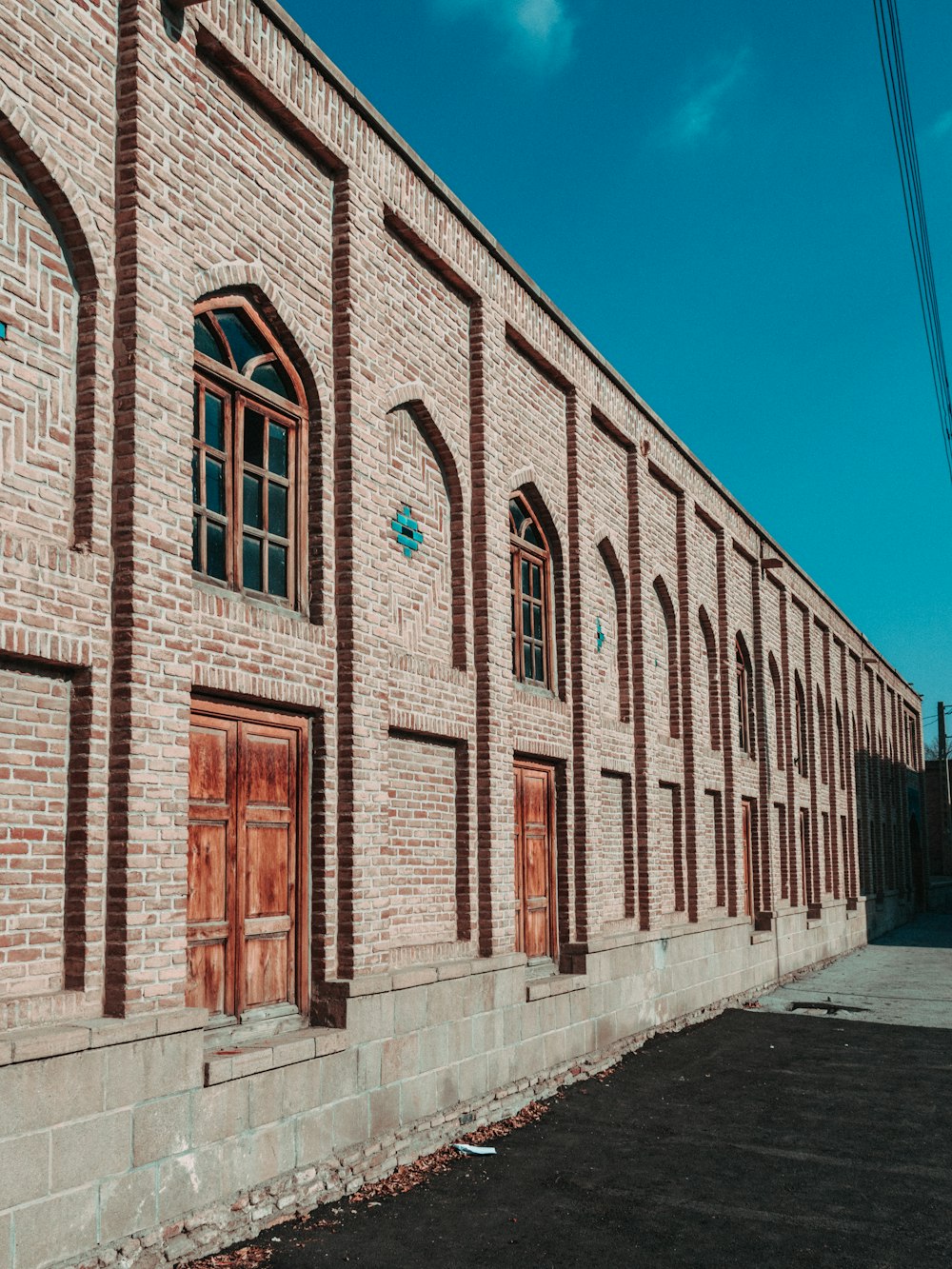 a brick building with wooden doors and windows