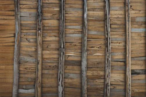 Photo of a rustic accent wall made from reclaimed wood planks.