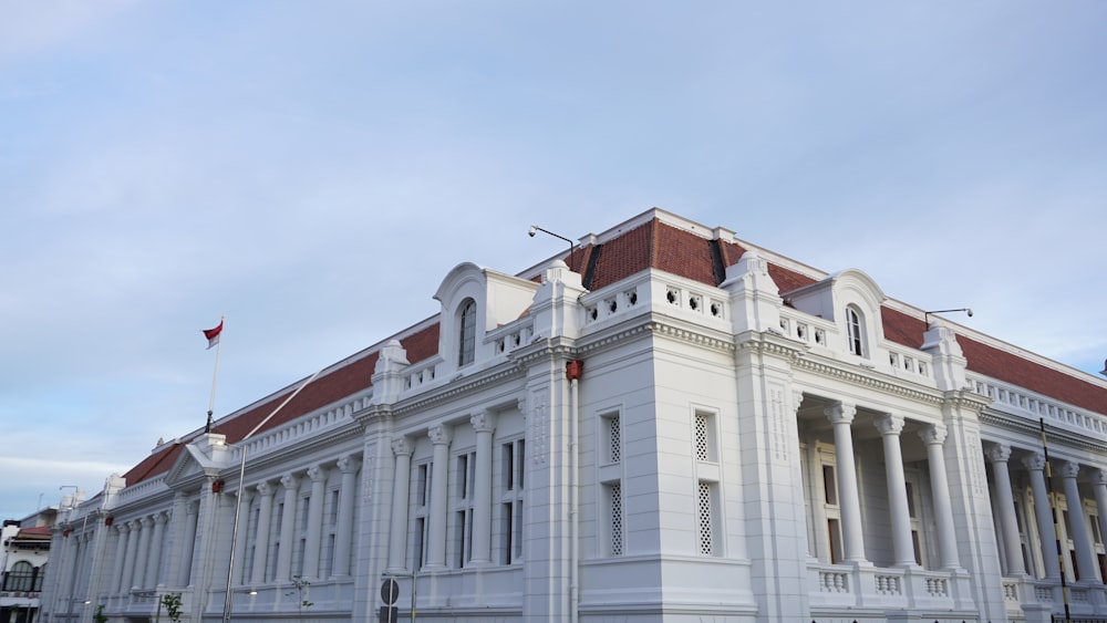 a large white building with a red roof