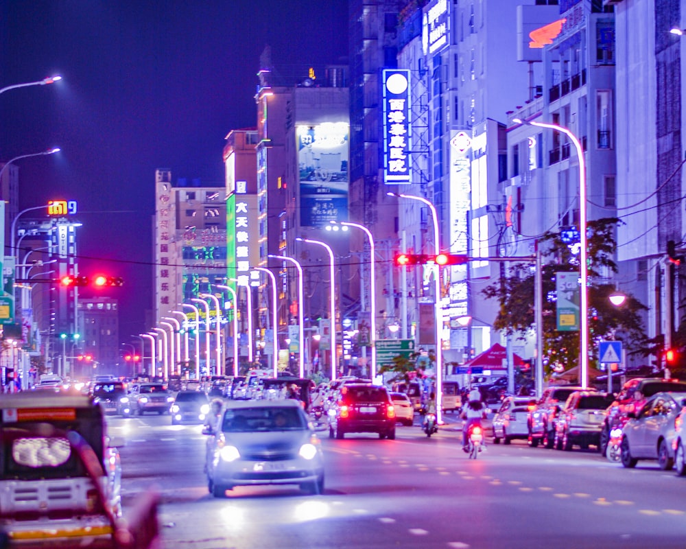 a city street filled with lots of traffic at night