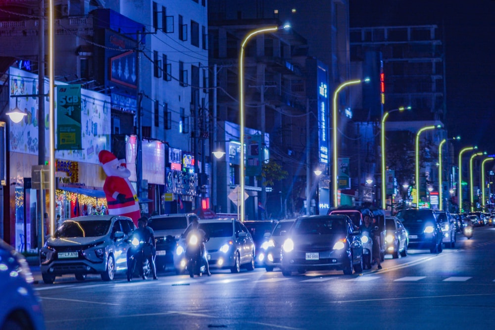 a city street filled with lots of traffic at night