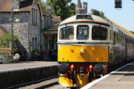 Passengers boarding a classic train at a charming vintage station.