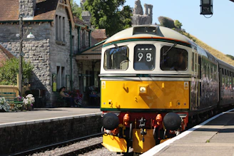 Passengers boarding a classic train at a charming vintage station.