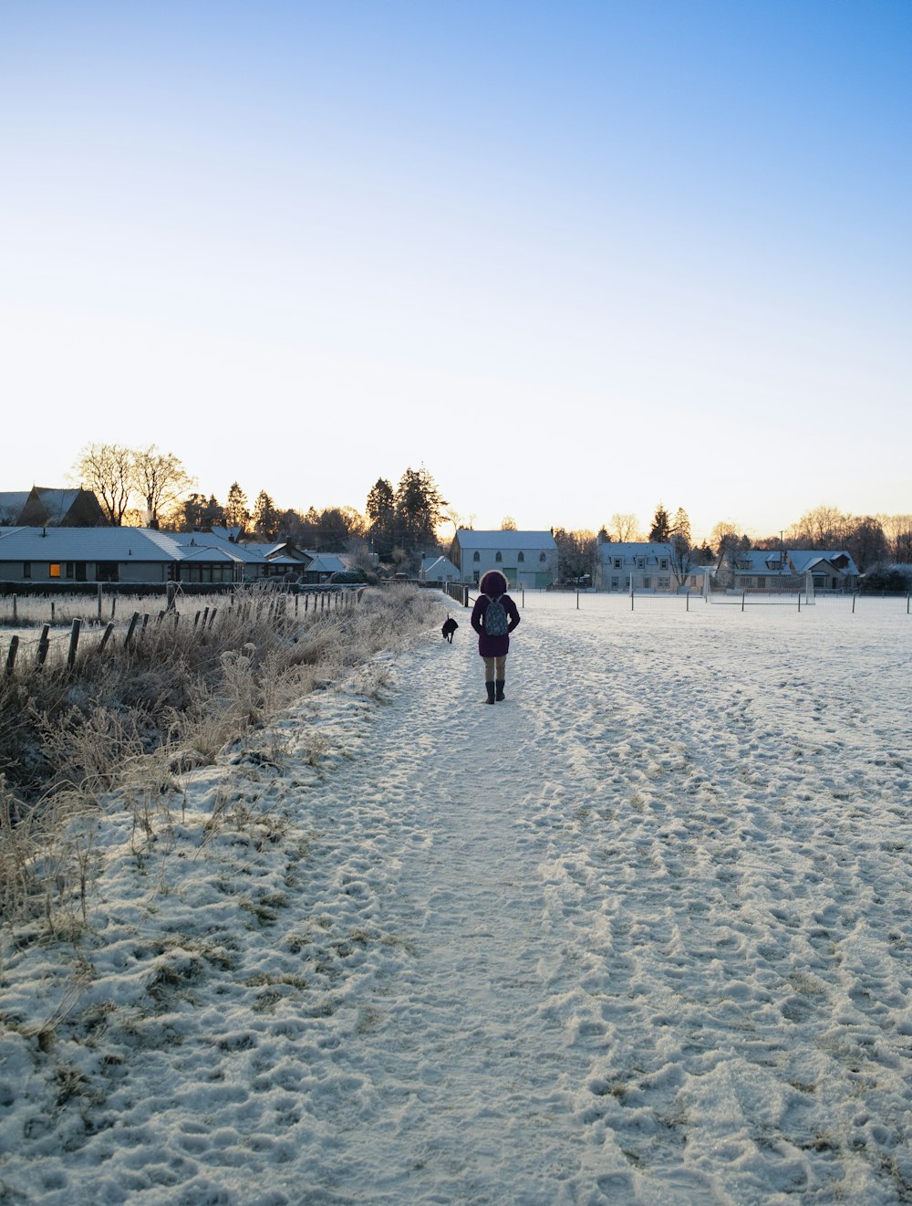 a person walking down a snow covered path