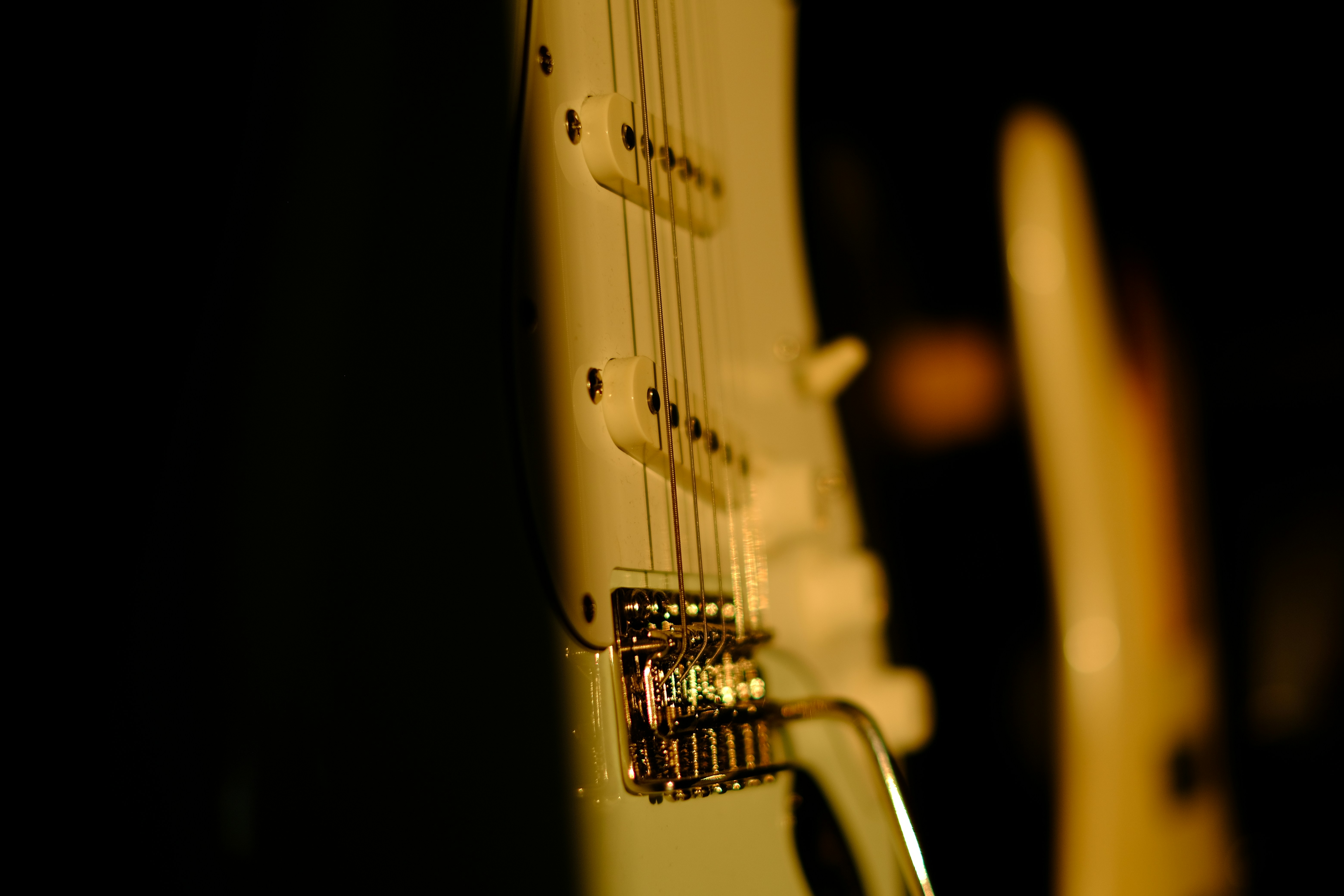 a close up of a white electric guitar